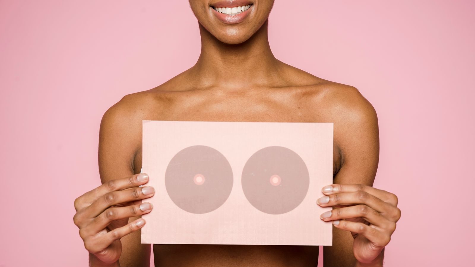 A conceptual image highlighting breast cancer awareness with a woman holding a symbolic card.